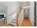 Bright foyer featuring a staircase with wooden handrails and hardwood floors leading into the home at 1217 Club Walk Ne Dr, Brookhaven, GA 30319