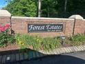 Forest Estates on Lake Spivey entrance sign with brick wall and lush greenery at 2237 Walt Stephens Rd, Jonesboro, GA 30236