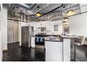 Contemporary kitchen featuring white cabinets, stainless steel appliances, and a breakfast bar area at 878 Peachtree Ne St # 634, Atlanta, GA 30309