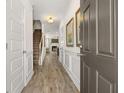 Inviting hallway featuring wood floors, decorative wainscoting, and access to the main living area at 1125 Elowen Dr, Austell, GA 30168