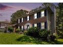 Charming two-story brick home with black shutters photographed at dusk at 1956 Spencer Oaks Ln, Lithonia, GA 30058