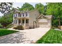 Beautifully landscaped home with a spacious driveway and a basketball hoop near the garage at 2370 Burch Cir, Brookhaven, GA 30319
