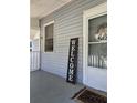 Cozy front porch area with charming decor, including a 'welcome' sign and a decorative wreath at 5108 Hackett Ne St, Covington, GA 30014