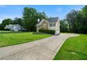 Beautiful home boasts a long driveway and lush green lawn and mature trees at 71 Headland Ct, Rockmart, GA 30153