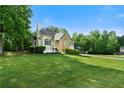 Lovely home with a sprawling green lawn, mature trees, and classic architecture at 71 Headland Ct, Rockmart, GA 30153