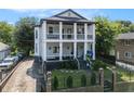 Classic two-story home with inviting double porches, a charming front yard, and a stone driveway at 918 Washington Sw St, Atlanta, GA 30315