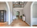 Spacious foyer with hardwood flooring, archways, and a staircase leading to the upper level at 1325 Starboard Way, Cumming, GA 30041