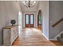 Elegant foyer boasting hardwood floors, arched doorways, and a statement chandelier at 1325 Starboard Way, Cumming, GA 30041
