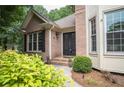 Charming brick home featuring a double door entry and well-manicured landscaping at 1325 Starboard Way, Cumming, GA 30041