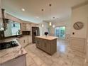 Spacious kitchen featuring an island, stainless steel appliances, and marble countertops at 2610 Stokesley Way, Snellville, GA 30078