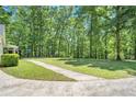 Expansive backyard of this home with mature trees and a partial view of the playset at 4840 Chapel Hill Rd, Douglasville, GA 30135