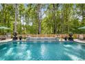 Refreshing in-ground pool with a decorative waterfall feature and ample space for outdoor seating at 771 Phil Haven Ln, Kennesaw, GA 30152