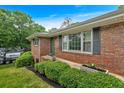 Close up of brick home featuring manicured bushes and a clean walkway at 14 Connie St, Cartersville, GA 30121