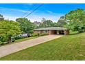 Beautiful brick home with long driveway, well-kept lawn, and covered carport at 14 Connie St, Cartersville, GA 30121