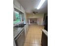 Traditional kitchen features granite countertops, double sink, tile flooring, and views to the living room at 801 Needle Rock Dr, Stone Mountain, GA 30083