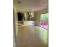 Living room with tile floors, and a sliding glass door that opens to the outdoor patio at 801 Needle Rock Dr, Stone Mountain, GA 30083