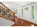 Bright entryway with hardwood floors and staircase featuring natural light through the large windows at 111 Millstone Way, Canton, GA 30115