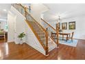 Inviting hardwood foyer with staircase, dining room, and elegant details including wainscoting at 111 Millstone Way, Canton, GA 30115