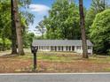 Welcoming home exterior with green trees surrounding the property at 1110 Upper Hembree Rd, Roswell, GA 30076