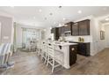 Open kitchen featuring an island with seating, stainless steel appliances, and wood-look floors at 1205 Elowen Dr, Austell, GA 30168