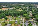 Overhead shot displays neighborhood homes nestled amongst mature trees, offering privacy and a serene setting at 140 Wilbanks St, Buford, GA 30518