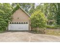 A large two-car garage with an adjacent fenced yard offers both functionality and curb appeal at 143 Cotton Mill Dr, Hiram, GA 30141