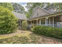 The side exterior shows a well-landscaped yard and a partial view of the home's architectural style at 143 Cotton Mill Dr, Hiram, GA 30141