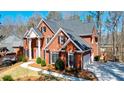 Stately brick home with well-maintained landscaping and an attached garage at 1105 River Laurel Dr, Suwanee, GA 30024