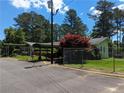 The exterior of this building offers covered parking and landscaped grounds on a sunny day at 395 Russell Sw Dr, Smyrna, GA 30082