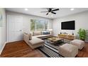 Bright living room featuring hardwood floors, a large window, and stylish furnishings at 624 Lyle Se Dr, Marietta, GA 30067