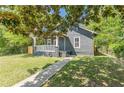 Charming bungalow with lush green front yard and inviting walkway at 1967 West John Calvin Ave, Atlanta, GA 30337