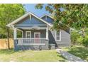 Charming bungalow featuring a covered front porch, fresh lawn and walkway at 1967 West John Calvin Ave, Atlanta, GA 30337