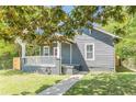 Charming bungalow with lush green front yard and inviting walkway at 1967 West John Calvin Ave, Atlanta, GA 30337