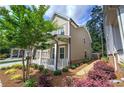 Exterior side view showcasing landscaped yard, mulch, green grass and a cozy porch, perfect for outdoor relaxation at 2657 Cedar Pine Way, Atlanta, GA 30360