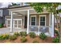 Inviting front porch with stylish seating area and lush landscaping, creating a warm and welcoming entrance at 2657 Cedar Pine Way, Atlanta, GA 30360