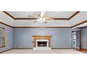 Inviting living room featuring a fireplace, vaulted ceilings with decorative trim and a ceiling fan at 2865 Bryant Ct, Cumming, GA 30040