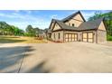 Long driveway leading to a spacious three-car garage, perfect for car enthusiasts and extra storage at 704 Rock Springs Rd, Lawrenceville, GA 30043