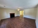 Spacious living room with wood flooring, fireplace, and fan offers ample space for relaxation at 1050 Redan Trce, Stone Mountain, GA 30088