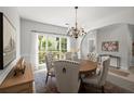 Bright dining room with stylish chandelier, comfortable chairs, and large window offering natural light and green views at 1050 Shady Valley Pl, Atlanta, GA 30324