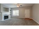 Open living room featuring a fireplace, large window, and a welcoming entrance at 4544 Parkview Sq, Atlanta, GA 30349