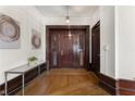 Elegant entryway featuring hardwood floors, paneled walls, and a console table with decorative items at 75 Ponce De Leon Ave # 701, Atlanta, GA 30308
