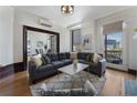 Comfortable living room with large windows offering city views, open to the dining area, and a fireplace at 75 Ponce De Leon Ave # 701, Atlanta, GA 30308