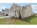 View of the single-story home with covered front porch and landscaped yard at 7760 Sheffield Ter, Fairburn, GA 30213
