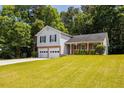 Inviting two-story home featuring a well-kept front lawn, two-car garage, and classic design at 6541 Lazy Creek Ct, Lithonia, GA 30058