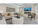 Stylish living room with modern fireplace, TV, neutral tones, and coordinated decor elements at 99 Silver Leaf Trce, Douglasville, GA 30134