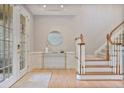 Bright foyer with wood floors, staircase, and French door leading to the outside at 2250 Norbury Se Dr, Smyrna, GA 30080
