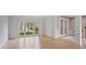 Bright living room with wood floors, large windows, and view of the front yard at 2250 Norbury Se Dr, Smyrna, GA 30080