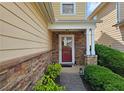 Inviting entryway featuring a stone facade and a stylish red front door at 2428 Black Forest Dr, Conyers, GA 30012