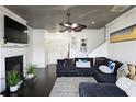 Cozy living room with dark floors, a fireplace, and a comfortable sectional sofa at 2428 Black Forest Dr, Conyers, GA 30012