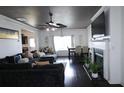 Open-concept living area featuring a fireplace, dining table, and dark wood floors at 2428 Black Forest Dr, Conyers, GA 30012